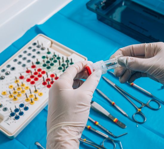 Hand holding a dental implant